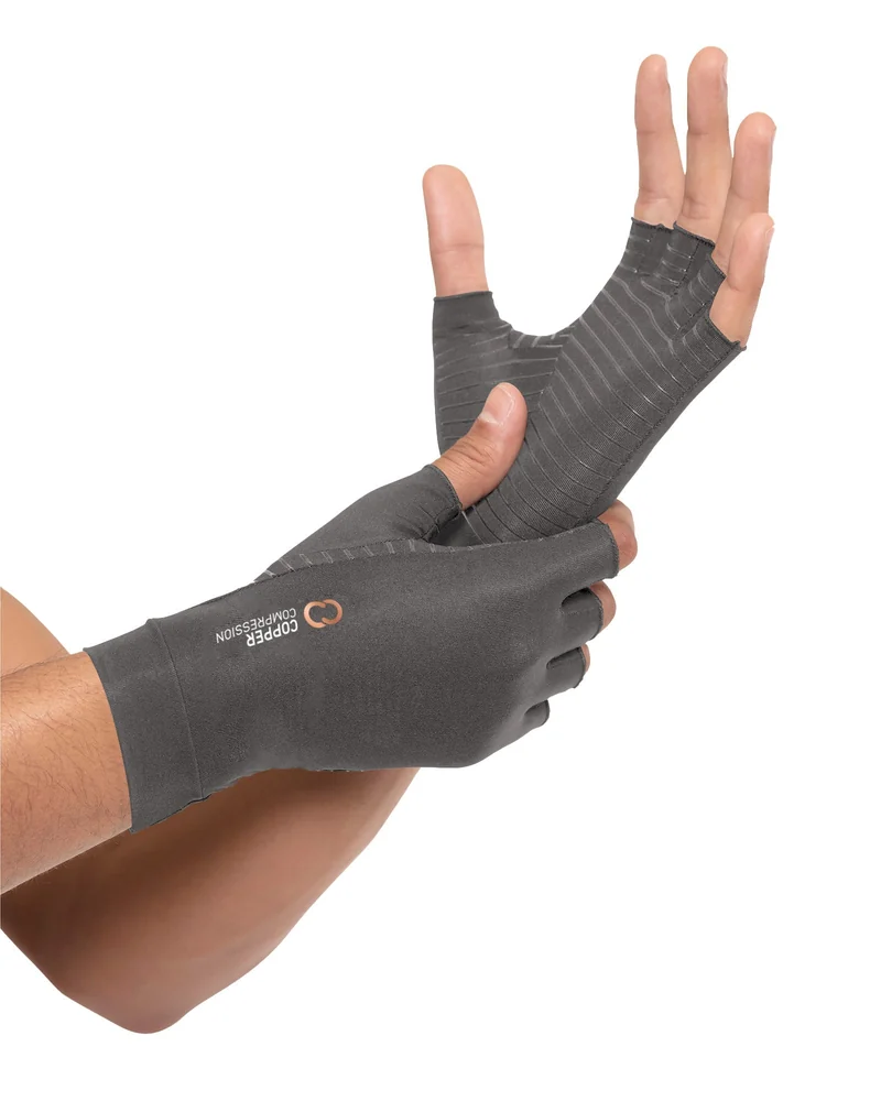 Copper Compression fingerless arthritis gloves in grey, worn on a hand